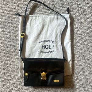 Chic Black and Gold Crossbody Bag with Structured Elegance